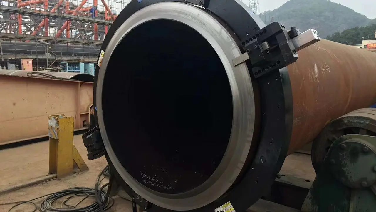 ISE T-Model ID-mount pipe beveling machine installed inside a medium-diameter carbon steel pipe in an industrial workshop, producing a clean 37.5-degree weld bevel